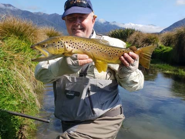 Craig Henderson, Australia with a South Island New Zealand brown trout, guided by Reefton fly fishing guide, Bryan Wilson